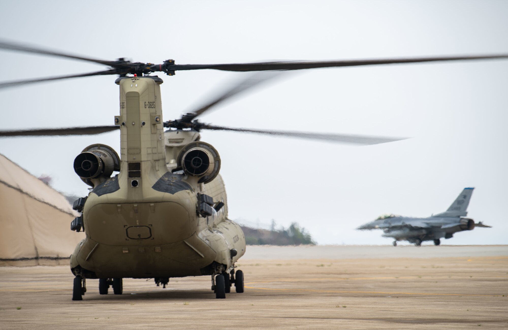 A CH-47 Chinook helicopter, assigned to Bravo Company, 3-2 General Support Aviation Battalion, out of Camp Humphreys, Republic of Korea, prepares for take-off during a K-9 medical evacuation training event at Kunsan Air Base, ROK, April 26, 2022. Military working dog (MWD) teams from the 8th Security Forces Squadron participated in the joint medevac training with units from Camp Humphreys, to observe and calculate the steps needed to properly