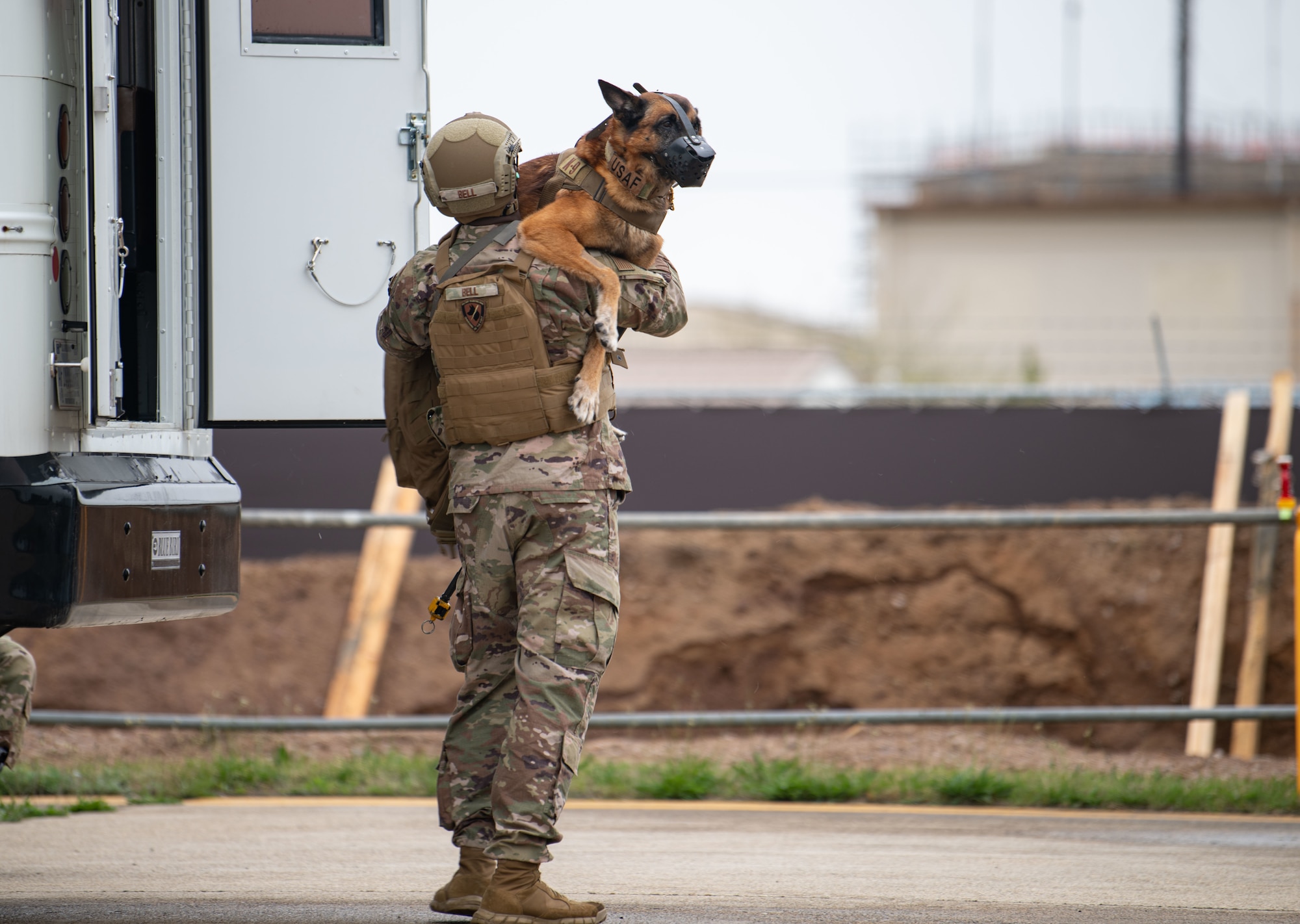 Senior Airman Jelani Bell, 8th Security Forces Squadron military working dog (MWD) handler, and MWD Hieno, prepare to board a CH-47 Chinook helicopter, assigned to U.S. Army Bravo Company, 3-2 General Support Aviation Battalion, out of Camp Humphreys, Republic of Korea, during a K-9 medical evacuation training event at Kunsan Air Base, ROK, April 26, 2022. The handlers gradually exposed the MWDs to the helicopters to familiarize them with the noises and vibrations to reduce their anxiety while flying. (U.S. Air Force photo by Staff Sgt. Gabrielle Spalding)