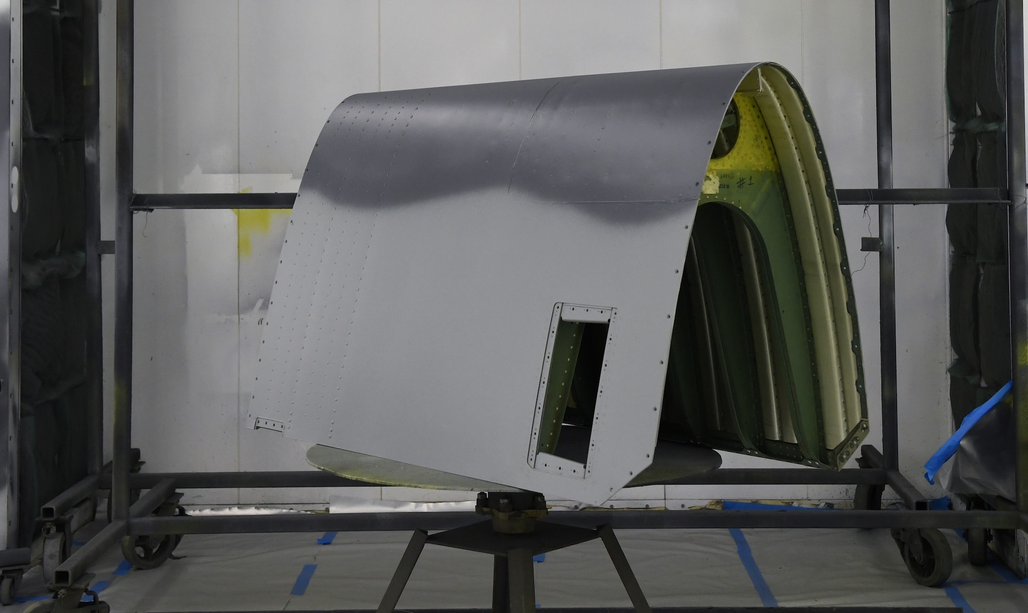 The fully repaired leading edge of an HC-130J Combat King II repair dries in a large painting room after it encountered a bird strike and required repairs, at Patrick SFB, Fla, April 25, 2022. (U.S. Air Force photo by Staff Sgt. Darius Sostre-Miroir)