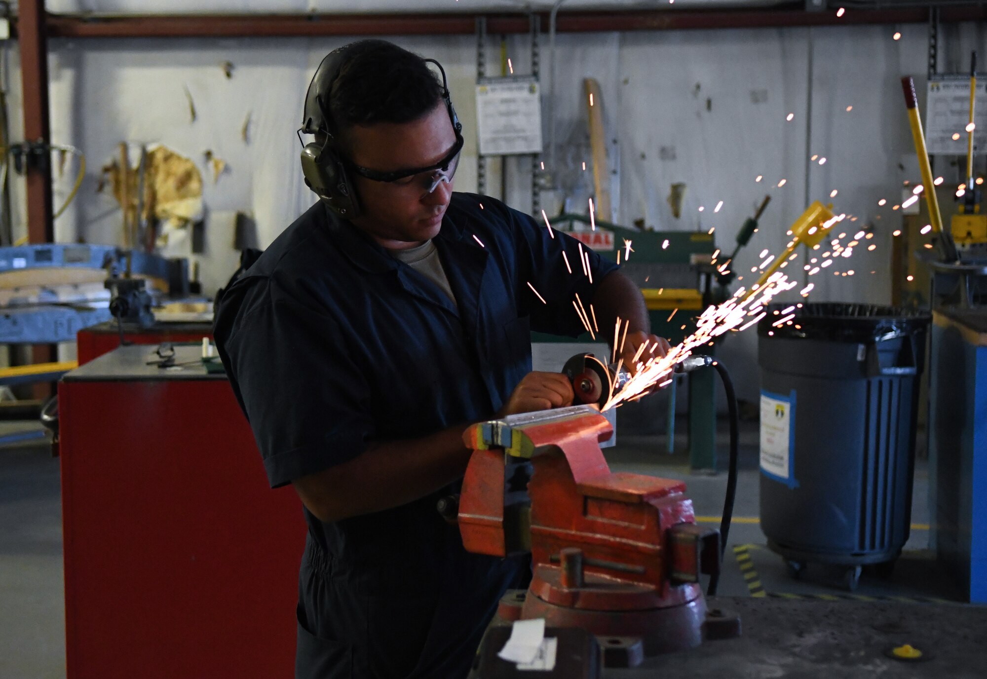 Technical Sgt. Eric Luna-Falcon, 920th Maintenance Squadron aircraft structural maintenance shop mechanic, cuts a piece of reinforcement plate with a cutting wheel after an HC-130J Combat King II encountered a bird strike and required repairs at Patrick Space Force Base, Fla., April 19, 2022. (U.S. Air Force photo by Staff Sgt. Darius Sostre-Miroir)