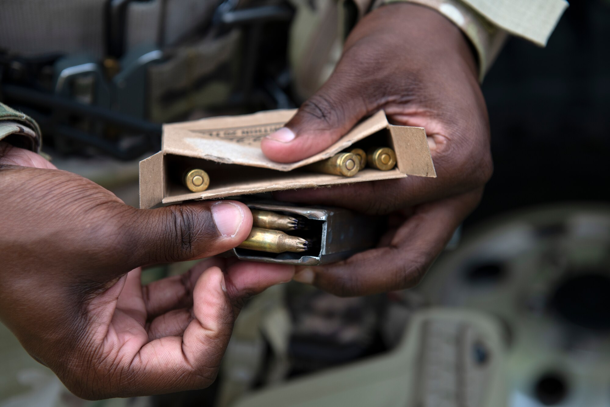 A U.S. Air Force Airman assigned to the 18th Security Forces Squadron loads a magazine with blank ammunition prior to a field training exercise at Kadena Air Base, Japan, April 27, 2022. When training with blank ammunition, firearms are outfitted with blank firing adapters, providing realistic operation of the firearm and maintaining the same cyclic rate of fire provided by conventional ammunition. (U.S. Air Force photo by Senior Airman Jessi Monte)