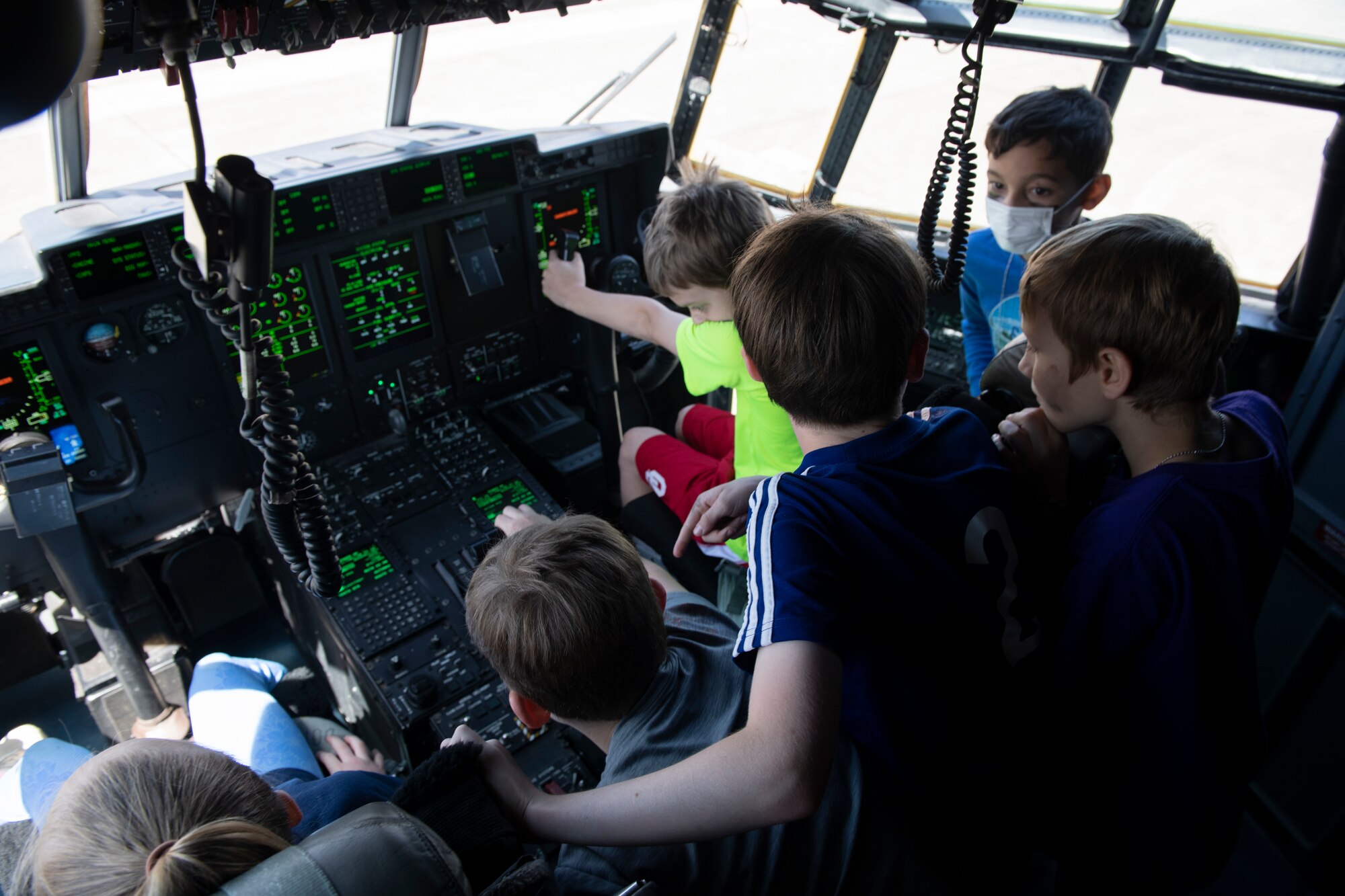 Operation Kids Understanding Deployment Operations participants look at the inside of a C-130J Super Hercules as part of Operation K.U.D.O.S. at Yokota Air Base, Japan, April 30, 2022. Operations K.U.D.O.S. consisted of toy weapon training, a C-130J Super Hercules tour and a mock medical checkup to simulate a deployed environment. (U.S. Air Force photo by Tech. Sgt. Joshua Edwards)