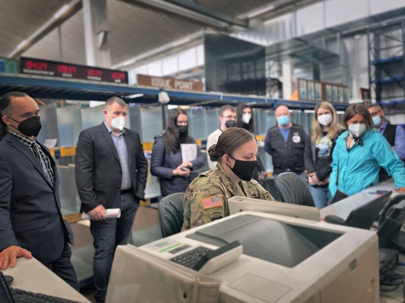 Col. ErvĪns Kopeika and his team from the Latvian State Defense Logistics and Procurement Centre and Keli'i Bright, along with members of his logistics team from the Logistics Readiness Centre-Italy observe a Soldier complete the procedure to check out the issued equipment that is assigned to her name. (Stefanie Mosley, U.S. Army Garrison Italy)