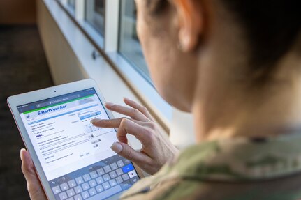 Sgt. Maj. Julie Harris, U.S. Army Financial Management Command operations senior enlisted advisor, uses a table device with her myPay pin and password to access the Defense Finance and Accounting Service’s SmartVoucher at the Maj. Gen. Emmett J. Bean Federal Center March 9, 2022. In August 2022, DFAS will add responsive design to SmartVoucher, which will make it even easier to use on personal devices. (U.S. Army photo by Mark R. W. Orders-Woempner)