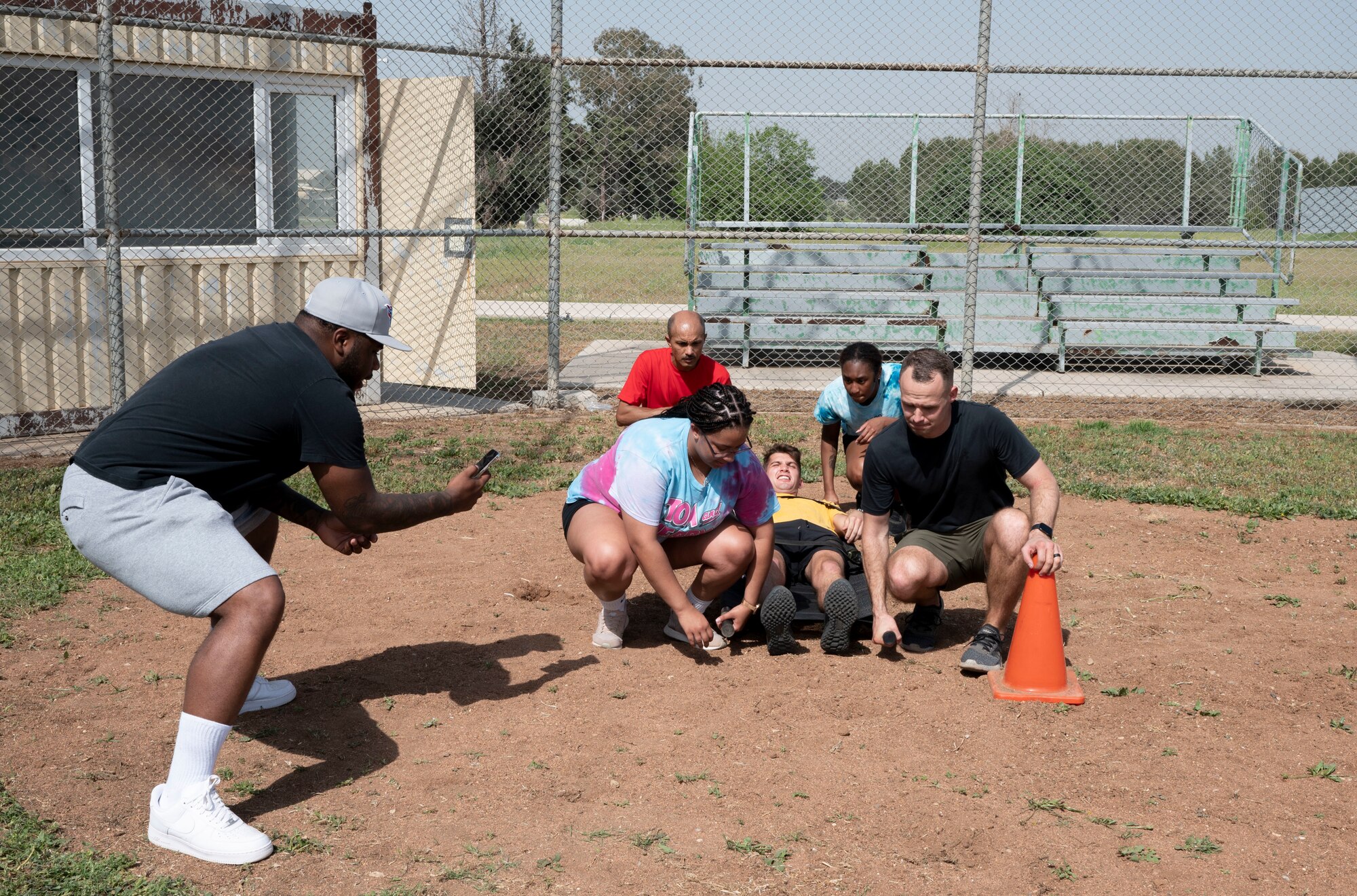 Team members assigned to various units across the 39th Air Base Wing participate in a litter carry challenge during a resiliency tactical pause race hosted by the 39th ABW at Incirlik Air Base, Turkey, April 29, 2022. The race consisted of teams gathering together to complete a list of obstacle courses around Incirlik AB. This event served to enhance resiliency by forming meaningful connections and promote alcohol awareness and sexual assault prevention. (U.S. Air Force photo by Staff Sgt. Gabrielle Winn)