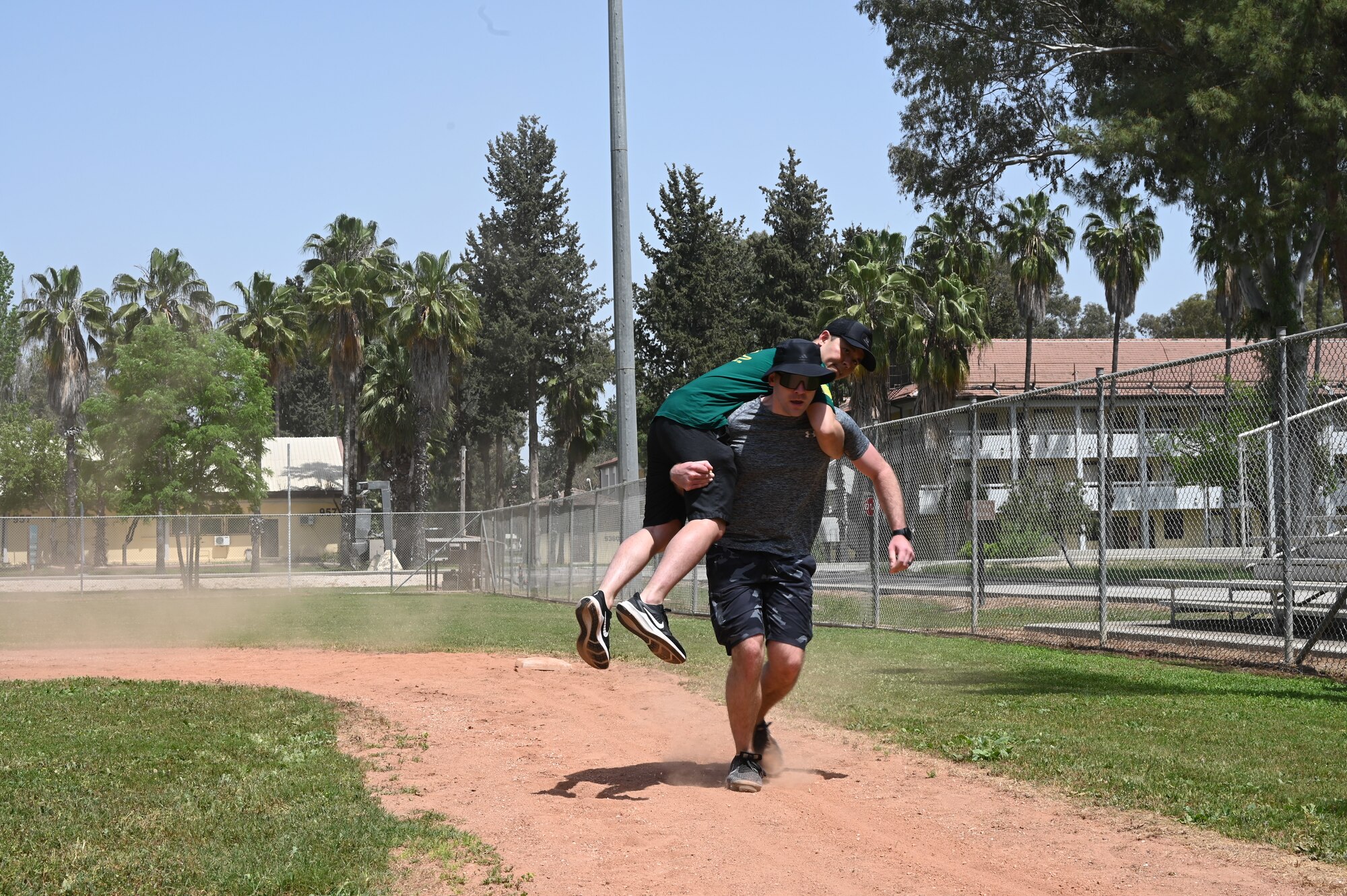Team members assigned to various units across the 39th Air Base Wing participate in a carry challenge simulating the effects of alcohol during a resiliency tactical pause race hosted by the 39th ABW at Incirlik Air Base, Turkey, April 29, 2022. The race consisted of teams gathering together to complete a list of obstacle courses around Incirlik AB. This event served to enhance resiliency by forming meaningful connections and promote alcohol awareness and sexual assault prevention. (U.S. Air Force photo by Staff Sgt. Gabrielle Winn)