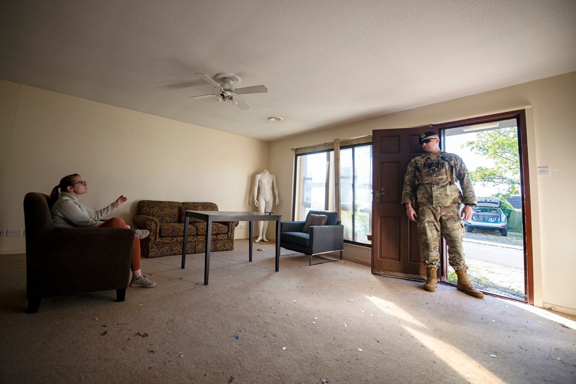 An Airman from the 423d Security Forces Squadron, right, speaks with a field training exercise participant at RAF Alconbury, England, April 26, 2022. The exercise was designed to evaluate the strengths and weaknesses of 423d SFS members' response to various scenarios including domestic disturbances, drunk driving and other base security incidents. (U.S. Air Force photo by Staff Sgt. Eugene Oliver)