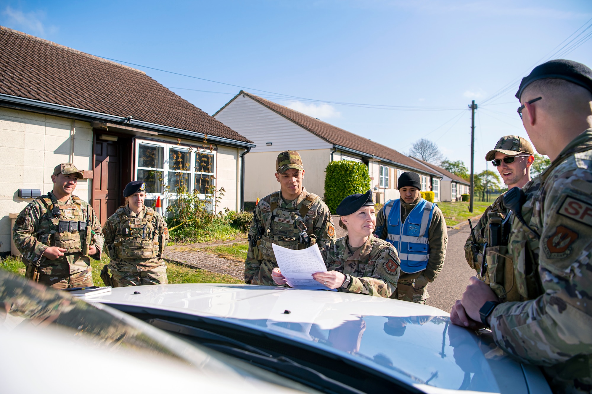 U.S. Air Force Master Sgt. Melissa Jackson, 423d Security Forces Squadron section chief of training, speaks with Airmen from the 423d SFS following a simulated domestic disturbance at RAF Alconbury, England, April 26, 2022. The exercise was designed to evaluate the strengths and weaknesses of 423d SFS members' response to various scenarios including domestic disturbances, drunk driving and other base security incidents. (U.S. Air Force photo by Staff Sgt. Eugene Oliver)