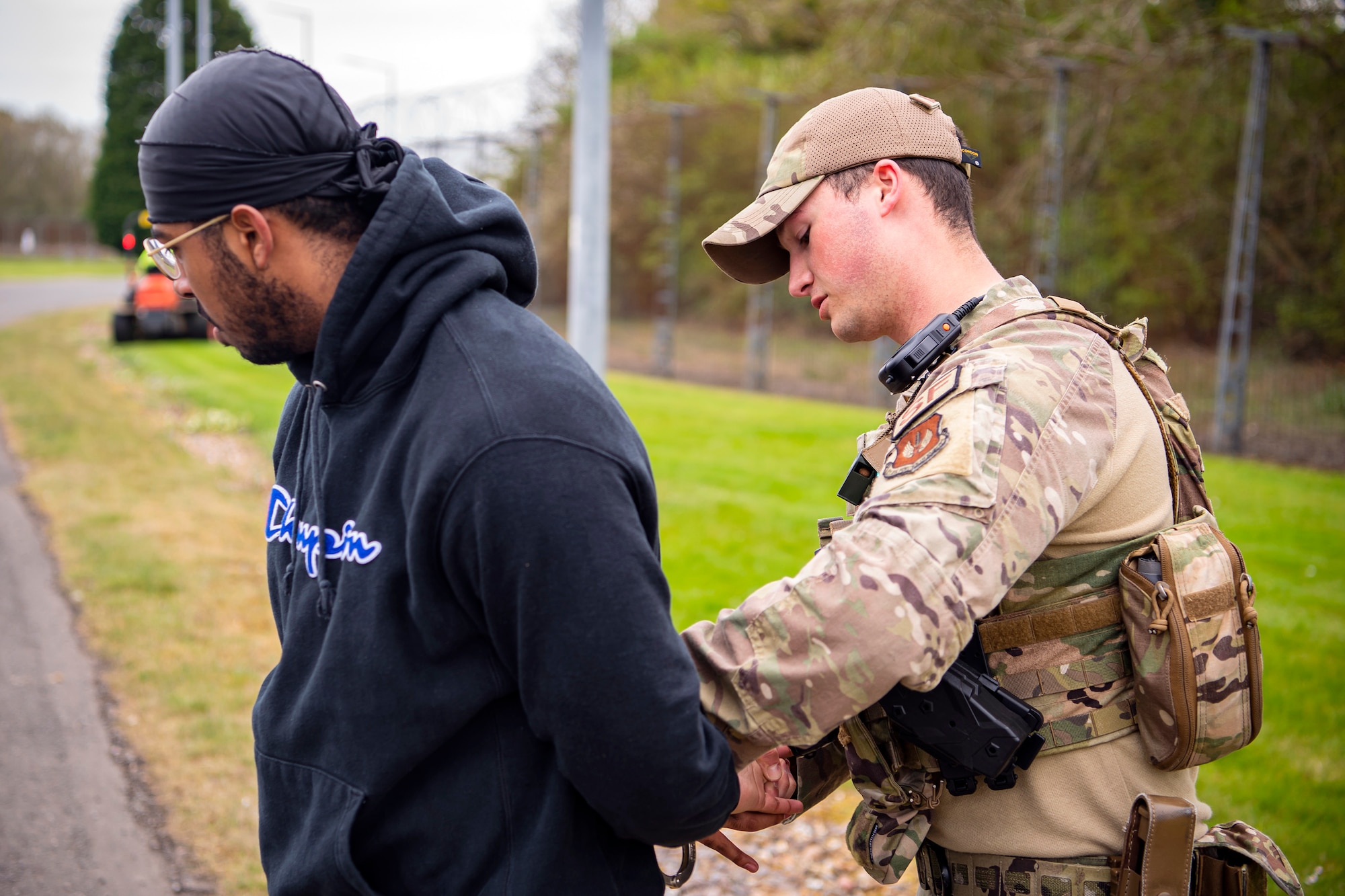 U.S. Air Force Senior Airman Zachary Hairston, 423rd Security Forces Squadron patrolman, apprehends a simulated suspect as part of a field training exercise at RAF Alconbury, England, April 27, 2022. The exercise was designed to evaluate the strengths and weaknesses of 423d SFS members' response to various scenarios including domestic disturbances, drunk driving and other base security incidents. (U.S. Air Force photo by Staff Sgt. Eugene Oliver)