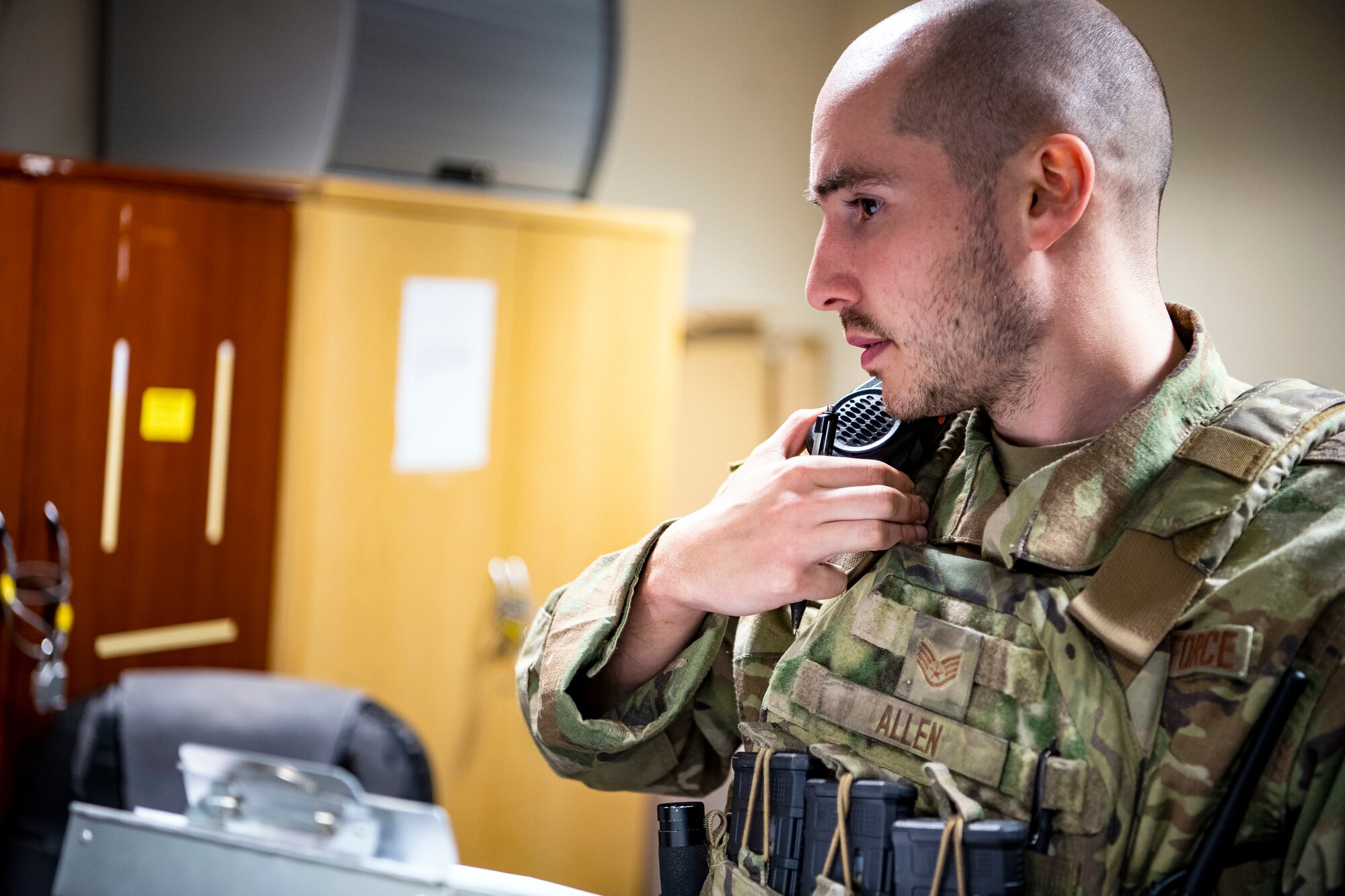 U.S. Air Force Staff Sgt. Elijah Allen, 423d Security Forces Squadron flight sergeant, speaks into his radio during a field training exercise at RAF Molesworth England, April 27, 2022. The exercise was designed to evaluate the strengths and weaknesses of 423d SFS members' response to various scenarios including domestic disturbances, drunk driving and other base security incidents. (U.S. Air Force photo by Staff Sgt. Eugene Oliver)