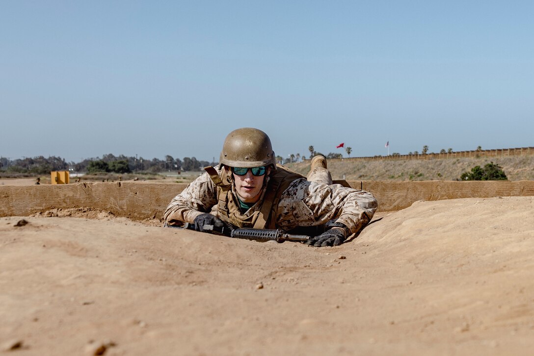 A U.S. Marine Corps officer candidate with Officer Selection Team San Diego, buddy rushes during an Officer Candidates School preparation weekend at Edson Range, Camp Pendleton, California on April 30, 2022. The OCS preparation weekend is designed to prepare aspiring Marine Corps officers mentally and physically for the rigors of OCS. (U.S. Marine Corps photo by Staff Sgt. Kelsey Dornfeld)