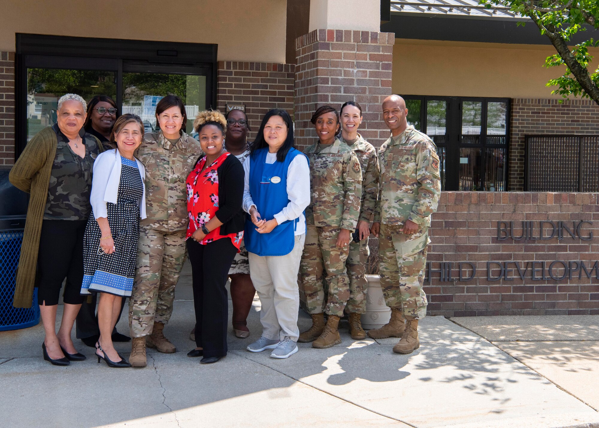 Chief Master Sgt. of the Air Force JoAnne S. Bass poses for a photo with members of her team and providers from the Child Development Center 2 at Joint Base Andrews, Md., April 27, 2022.