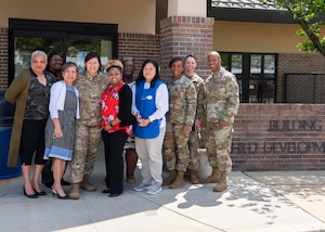 Chief Master Sgt. of the Air Force JoAnne S. Bass poses for a photo with members of her team and providers from the Child Development Center 2 at Joint Base Andrews, Md., April 27, 2022.
