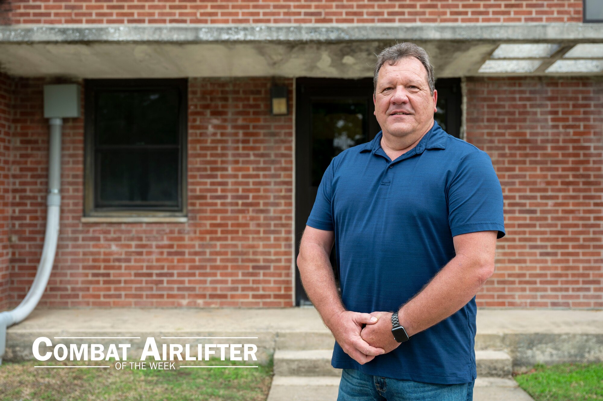 Wayne Bridges poses for a photo in front of a dorm building on Little Rock Air Force Base, Arkansas.