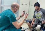 Earl Granville, a retired Army National Guard staff sergeant, discusses fixing his artificial limb with Tyler Cook, a prosthetist at Walter Reed National Military Medical Center (WRNMMC), in WRNMMC in Bethesda, Maryland, Apr. 23, 2022. Granville lost his leg in a combat mission abroad. He is one of many veterans that receive prosthetic support and maintenance from WRNMMC's prosthetics unit.