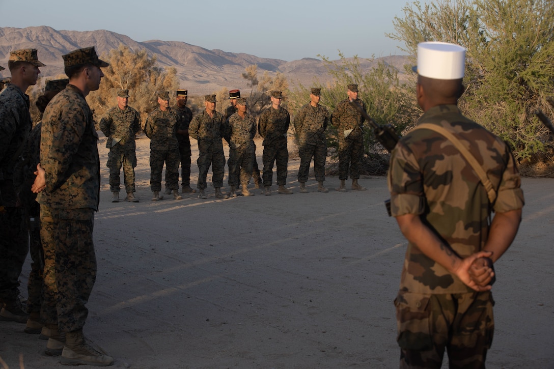 U.S. Marines with 1st Battalion, 6th Marine Regiment, 2d Marine Division, and French Foreign Legionnaires stand in a ceremony at Marine Corps Air Ground Combat Center, Twentynine Palms, California, April 30, 2022. The ceremony is in honor of the sixty-five French Foreign Legionnaires that fought bravely during the Battle of Camarone in 1863. (U.S. Marine Corps photo by Lance Cpl. Megan Ozaki)