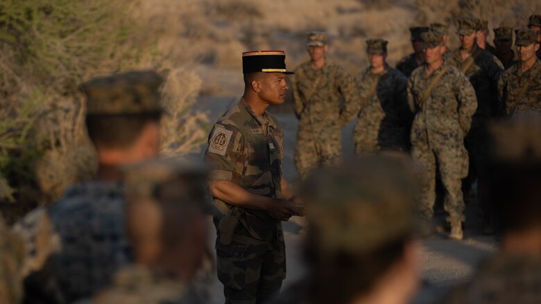 U.S. Marines with 1st Battalion, 6th Marine Regiment, 2d Marine Division, and French Foreign Legionnaires stand in a ceremony at Marine Corps Air Ground Combat Center, Twentynine Palms, California, April 30, 2022. The ceremony is in honor of the sixty-five French Foreign Legionnaires that fought bravely during the Battle of Camarone in 1863. (U.S. Marine Corps photo by Lance Cpl. Megan Ozaki)