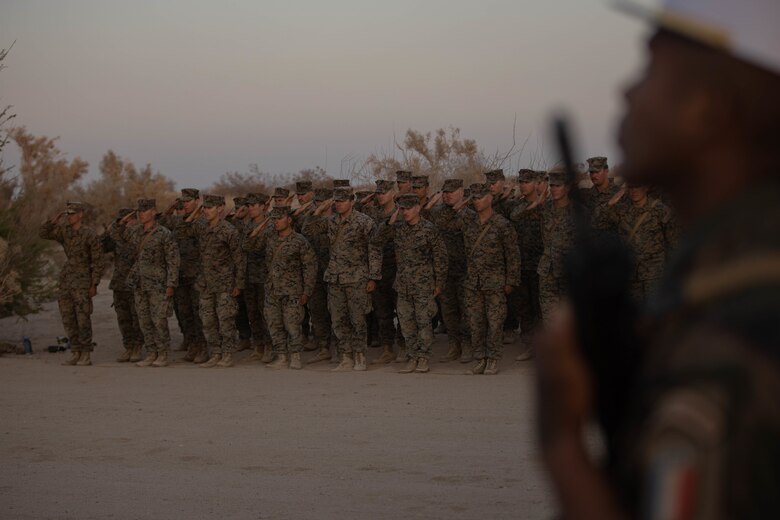 U.S. Marines with 1st Battalion, 6th Marine Regiment, 2d Marine Division, and French Foreign Legionnaires stand in a ceremony at Marine Corps Air Ground Combat Center, Twentynine Palms, California, April 30, 2022. The ceremony is in honor of the sixty-five French Foreign Legionnaires that fought bravely during the Battle of Camarone in 1863. (U.S. Marine Corps photo by Lance Cpl. Megan Ozaki)