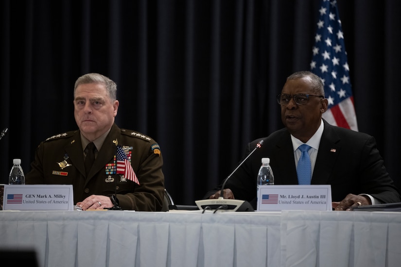 Two men sit at a table.