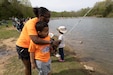 A Soldier fishes with her son