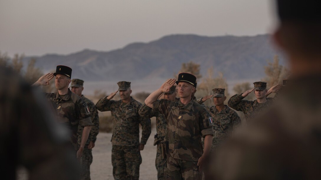 U.S. Marines with 1st Battalion, 6th Marine Regiment, 2d Marine Division, and French Foreign Legionnaires stand in a ceremony at Marine Corps Air Ground Combat Center, Twentynine Palms, California, April 30, 2022. The ceremony is in honor of the sixty-five French Foreign Legionnaires that fought bravely during the Battle of Camaron in 1863. (U.S. Marine Corps photo by Lance Cpl. Megan Ozaki)