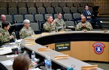 Soldiers having a discussion around a table.