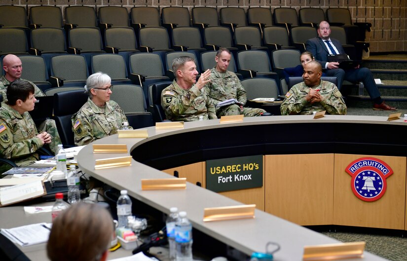 Soldiers having a discussion around a table.