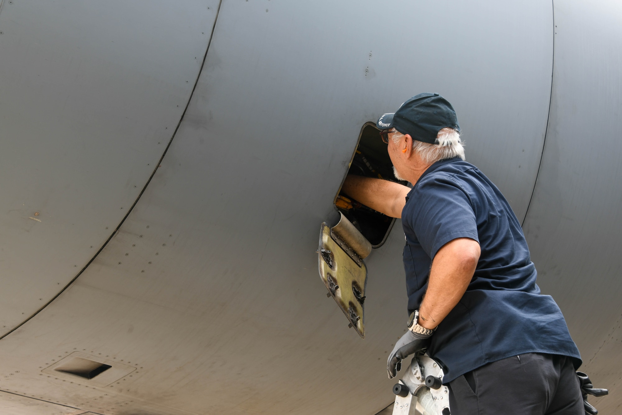 Jay Chase, 97th Maintenance Squadron (MXS) C-17 Globemaster III crew chief, changes oil in a C-17 engine at Kelly Airfield, Texas, April 27, 2022. The 97th MXS provided support for all three flying squadrons from the 97th Operations Group during Task Force Red Mammoth. (U.S. Air Force photo by Airman 1st Class Trenton Jancze)