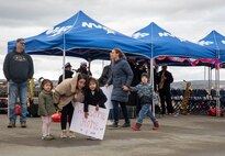 A family waits for their Sailor after Arleigh Burke-class guided-missile destroyer USS McCampbell (DDG 85) arrived to its new homeport of Naval Station Everett, Washington April 8, 2022. Prior to relocating, the ship underwent an extensive Depot Modernization Period in Portland, Oregon that spanned more than 18 months. The modernization included improvements to the hull, mechanical systems, electrical technology, wireless communications, and weapon upgrades. This routine maintenance ensures the ship can continue to be mission capable throughout its expected service life. (U.S. Navy photo by Mass Communication Specialist 2nd Class Ethan Soto)