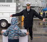 A Sailor reunites with his family after Arleigh Burke-class guided-missile destroyer USS McCampbell (DDG 85) arrived to its new homeport of Naval Station Everett, Washington April 8, 2022. Prior to relocating, the ship underwent an extensive Depot Modernization Period in Portland, Oregon that spanned more than 18 months. The modernization included improvements to the hull, mechanical systems, electrical technology, wireless communications, and weapon upgrades. This routine maintenance ensures the ship can continue to be mission capable throughout its expected service life. (U.S. Navy photo by Mass Communication Specialist 2nd Class Ethan Soto)