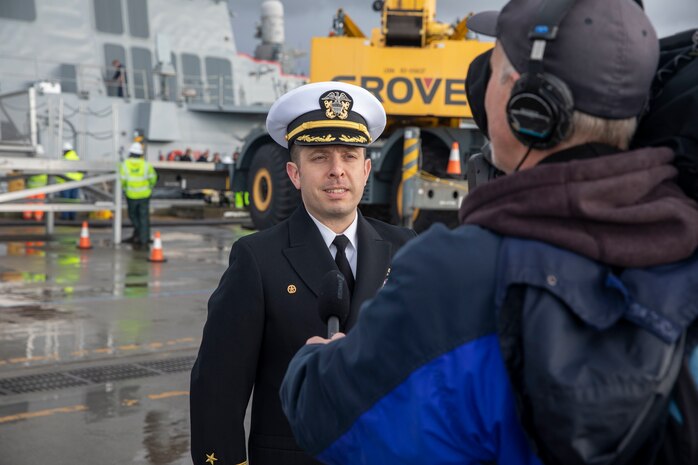 Cmdr. Steven Zielechowski, commanding officer of Arleigh Burke-class guided-missile destroyer USS McCampbell (DDG 85), speaks to media after the ship arrived to its new homeport of Naval Station Everett, Washington April 8, 2022. Prior to relocating, the ship underwent an extensive Depot Modernization Period in Portland, Oregon that spanned more than 18 months. The modernization included improvements to the hull, mechanical systems, electrical technology, wireless communications, and weapon upgrades. This routine maintenance ensures the ship can continue to be mission capable throughout its expected service life. (U.S. Navy photo by Mass Communication Specialist 2nd Class Ethan Soto)