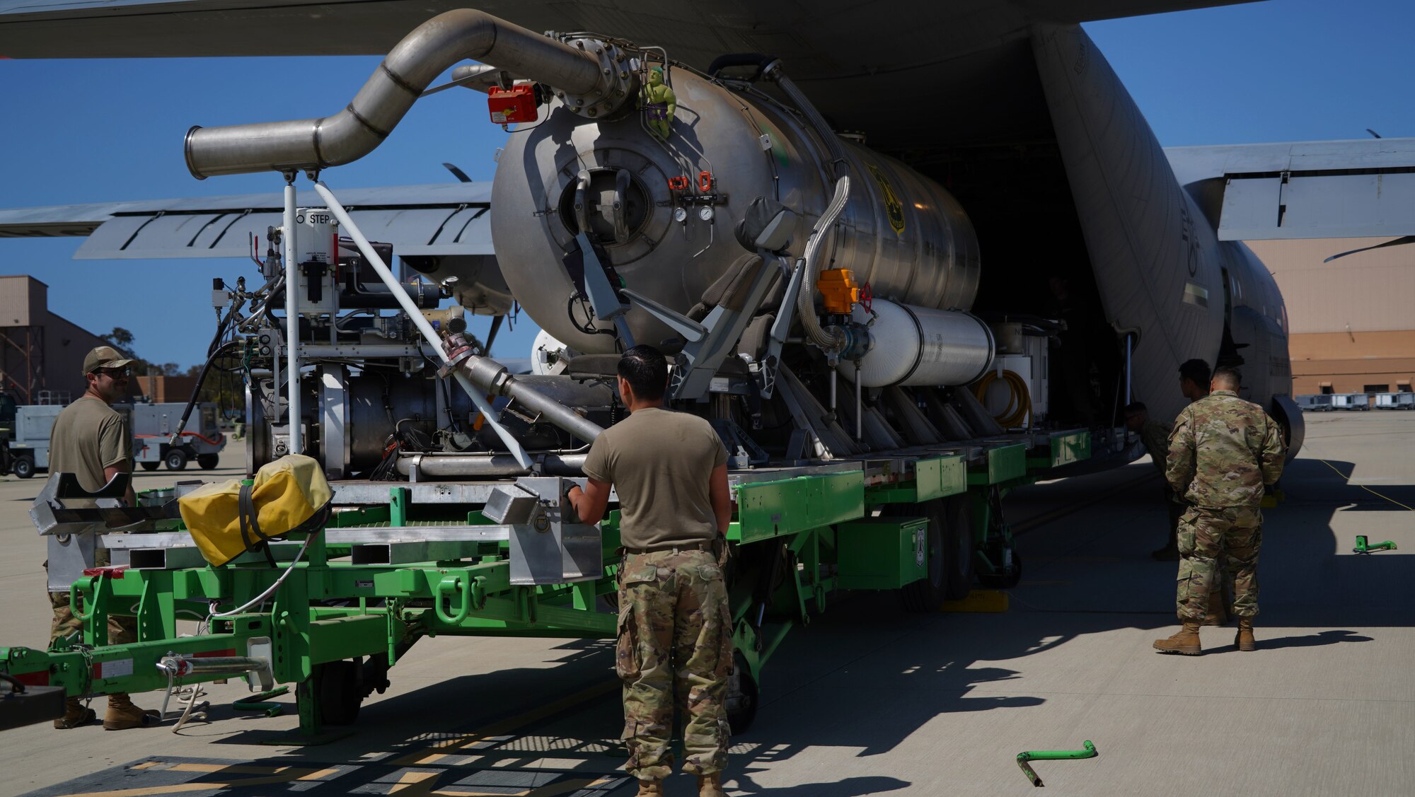 U.S. Air Force personnel from the 146th Airlift Wing load the U.S. Forest Service's Modular Airborne Firefighting System (MAFFS) inside a C-130J Super Hercules aircraft