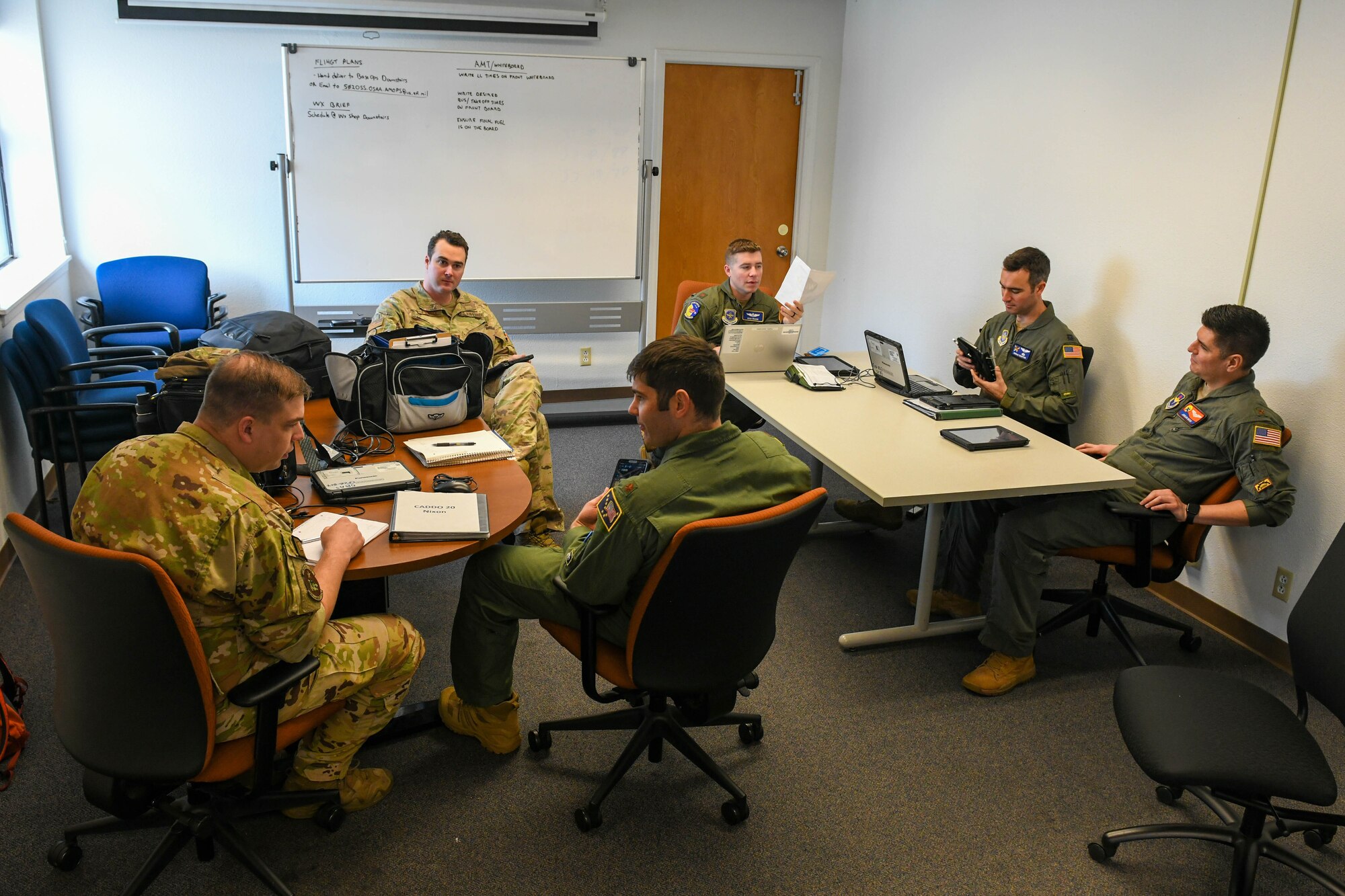 C-17 Globemaster III pilots perform mission planning during Task Force Red Mammoth at Kelly Airfield, Texas, April 27, 2022. Red Mammoth provided an opportunity to execute aircrew student training at displaced locations. (U.S. Air Force photo by Airman 1st Class Trenton Jancze)