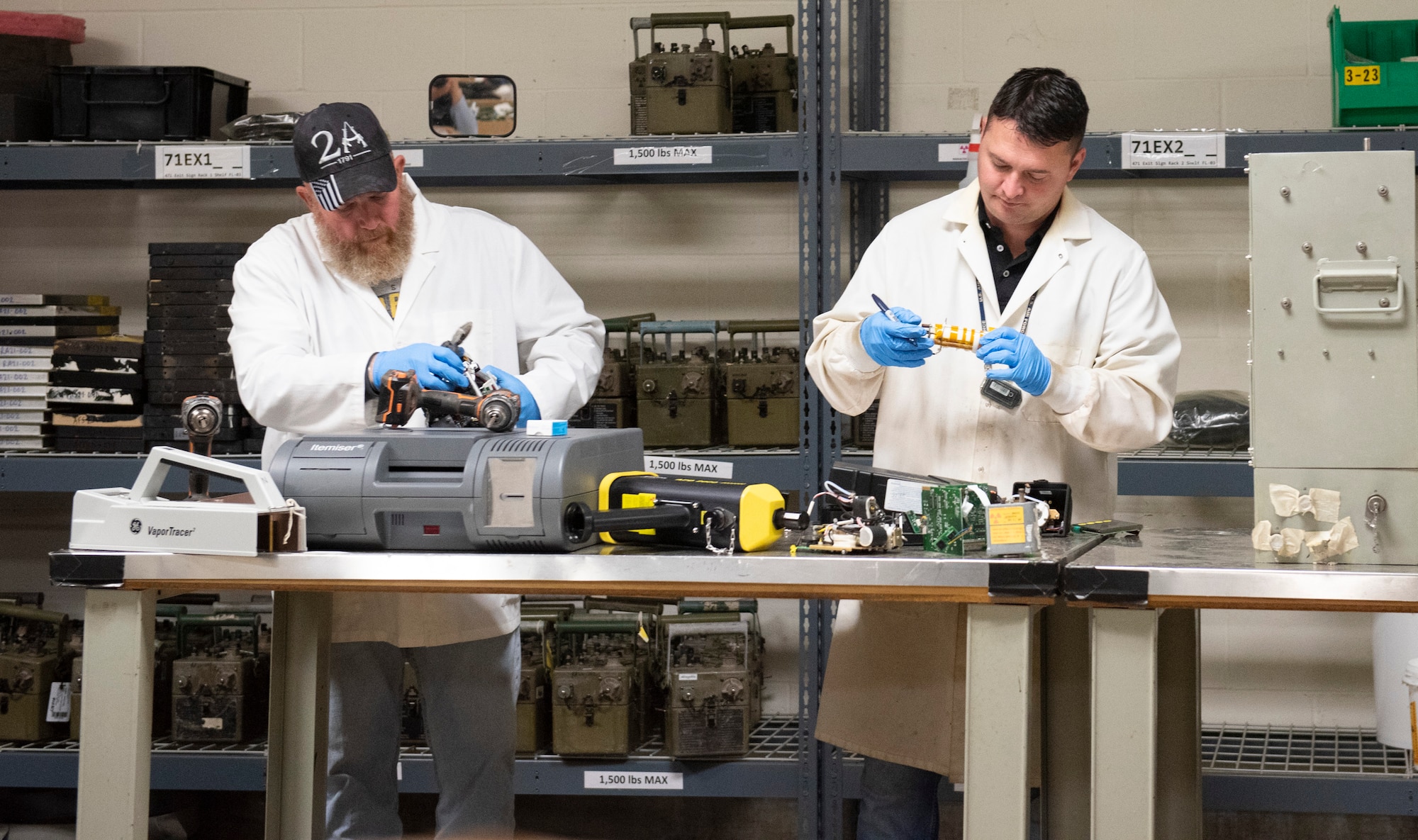 Charlie Mitchell (left) and Seth Walton (right) inspect and remove radioactive components from pieces of equipment at the Air Force Radioactive Recycling and Disposal facility at Wright-Patterson Air Force Base, Ohio. AFRRAD won the 2022 Secretary of Defense Environmental Award for Environmental Quality. (U.S. Air Force photo by Jaima Fogg)