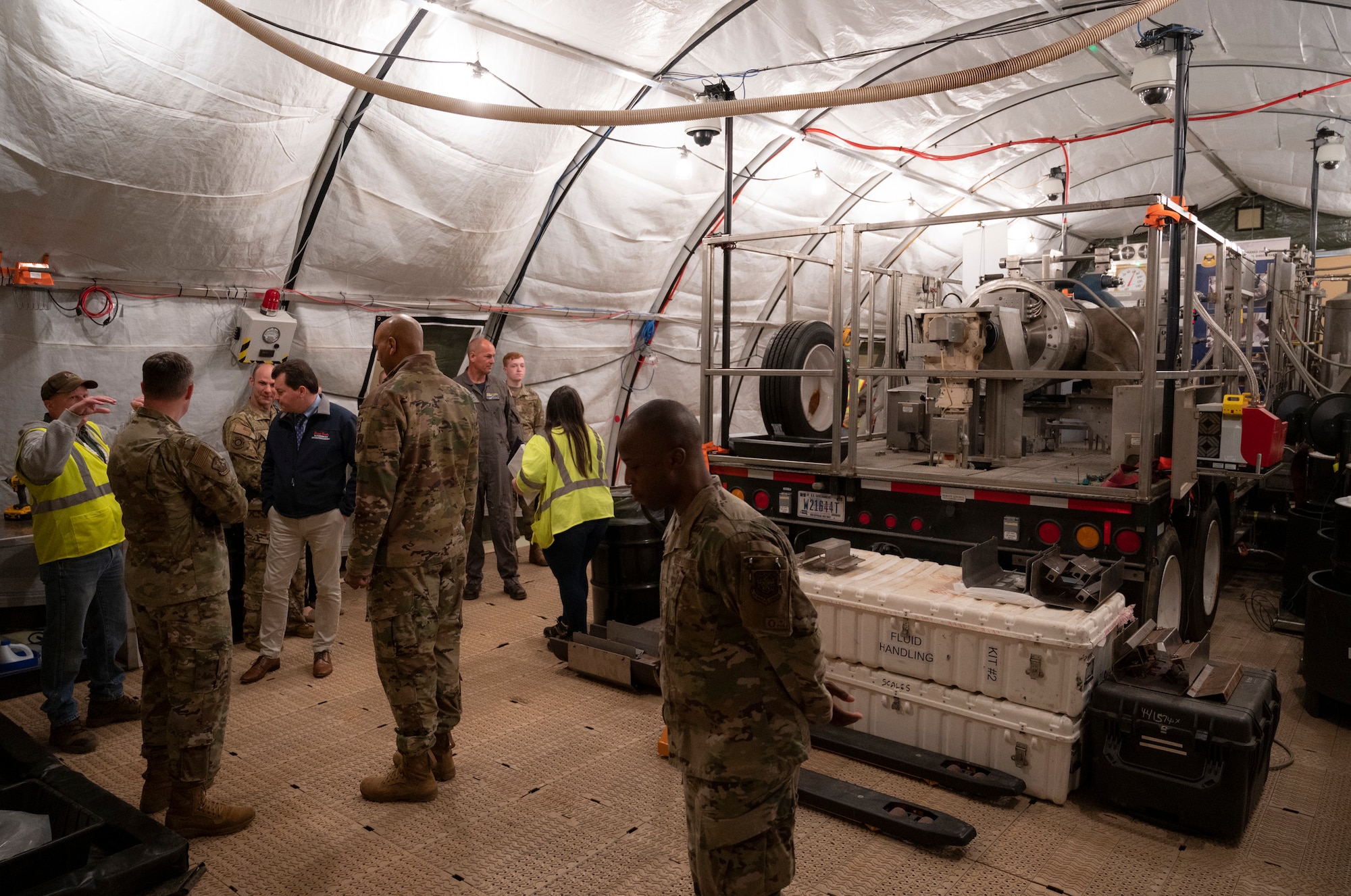 Joint Base McGuire-Dix-Lakehurst leadership is briefed on the process of explosive destruction and assessments during a tour of the destruction site hosted by the Recovered Chemical Materiel Directorate, May 2, 2022, on Joint Base MDL, New Jersey. RCMA partnered with Joint Base MDL for a second mission to destroy World War I-era chemical munitions after discovering a six 75mm projectiles at Joint Base MDL’s Parachute Jump Circle while investigating and removing chemical munitions, munitions of explosive concern and/or munitions constituents from two disposal pits. (U.S. Air Force photo by Staff Sgt. Ariel Owings)