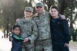 Maj. Sara Salmeri, 60th Medical Group TRICARE operations flight commander, and Tech. Sgt. Peter Salmeri, 60th Communication Squadron cyber systems supervisor, pose for a photo with their children for the Military Spouse Appreciation Day campaign at Travis Air Force Base, Calif., April 7, 2022. May 6th is Military Spouse Appreciation Day, and Travis AFB is celebrating by highlighting the resiliency and commitment of spouses in the military community. (U.S. Air Force photo by Chustine Minoda)