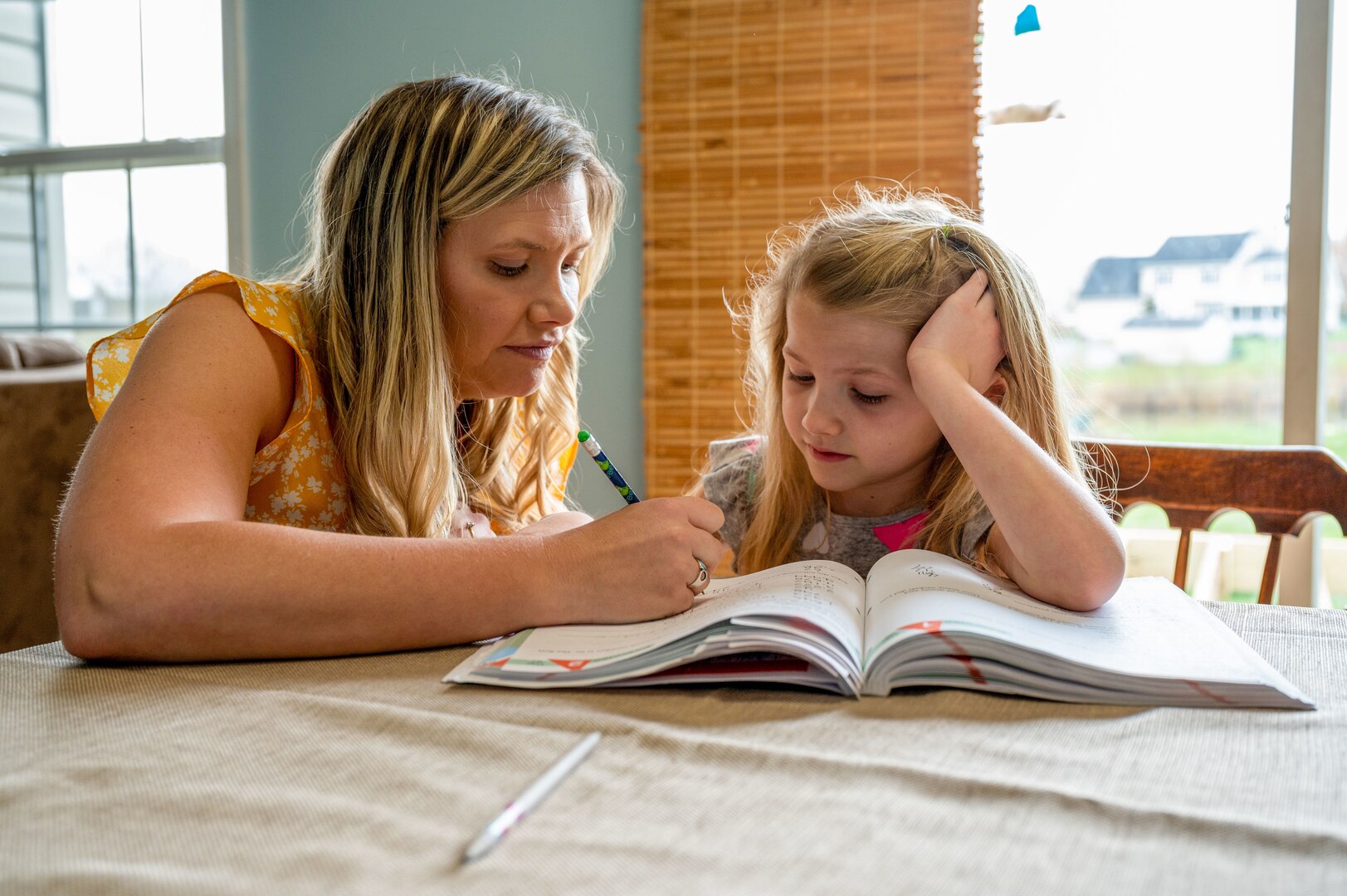 Rachel Young teaches her 8-year-old daughter, Melody, math concepts at their home in Magnolia, Del., April 5, 2022. Young is a full-time stay-at-home mother and homeschools her children. Young has been a military spouse for 12 years and said her husband’s unit has been a great and supportive community. (U.S. Air Force photo by Airman 1st Class Cydney Lee)