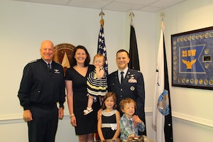 Chief of Space Operations Gen. John W. “Jay” Raymond poses for a photo after administering the oath of office to Lt. Col. Justin Spring when he transferred to the U.S. Space Force in July 2021 in the presence of his family in the Pentagon, Arlington, Va. The Space Force supports the development of families by partnering with the Air Force to improve access to childcare, housing, employment opportunities and resources. (Courtesy photo)