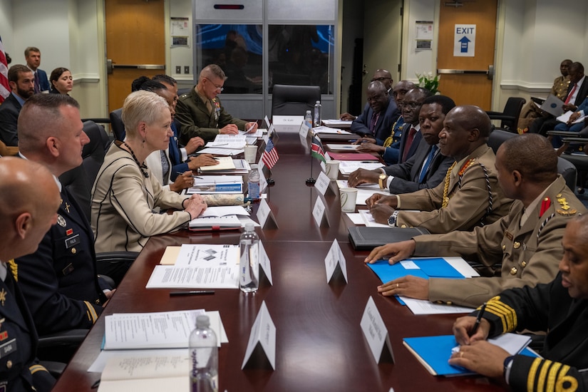 U.S. and Kenyan officials sit across from each other at a long table.
