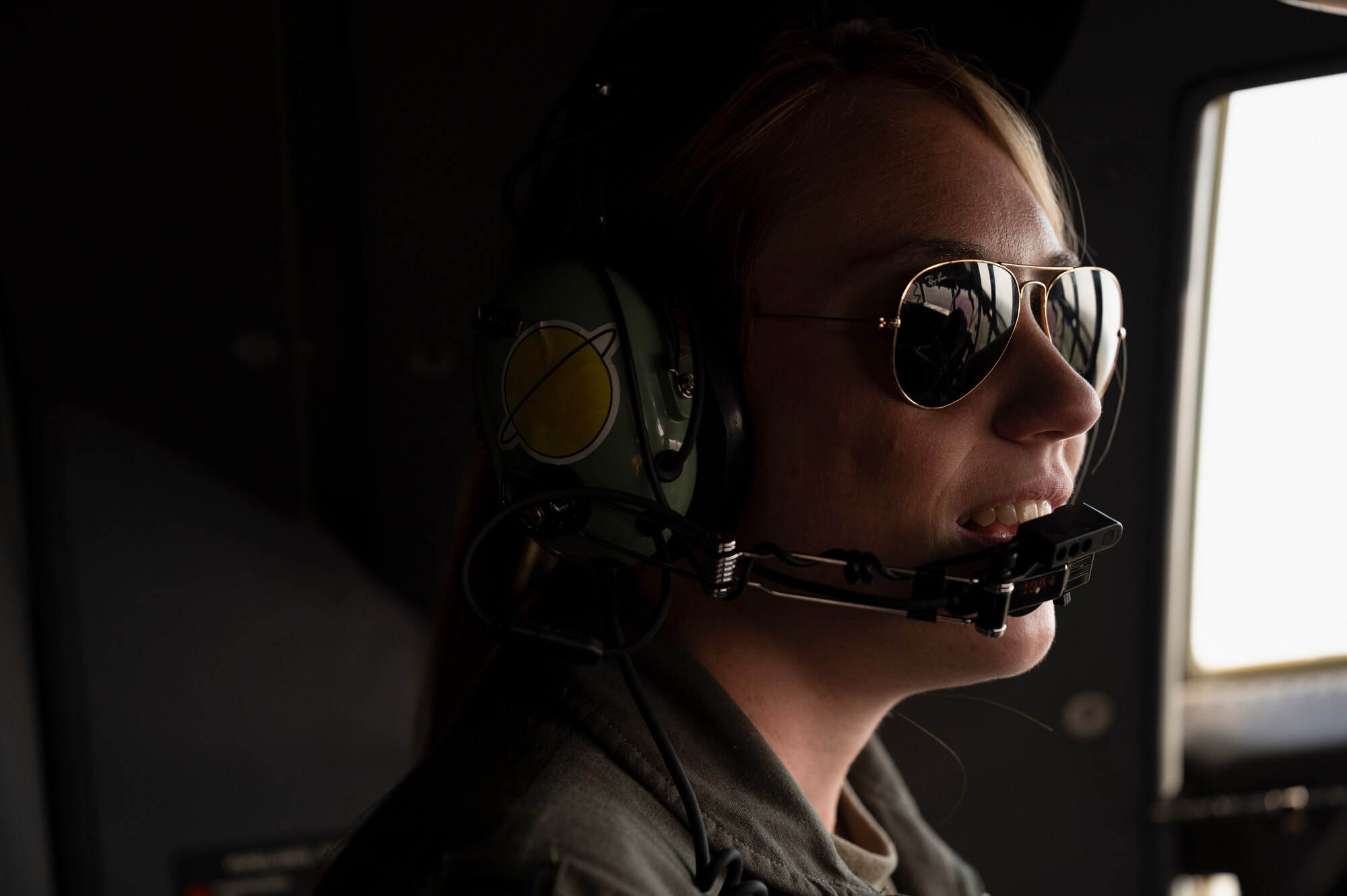 U.S. Air Force 1st Lt. Elizabeth Mahoney, 40th Airlift Squadron pilot, speaks with other aircrew members mid-flight from Dyess Air Force Base, Texas, to Avenger Field, Sweetwater, Texas, April 30, 2022. After landing, two all-female aircrews from the 317th Airlift Wing participated in a static display presentation, spoke with local media outlets and toured Sweetwater’s Women Airforce Service Pilot Museum as part of the 80th WASP Homecoming. (U.S. Air Force photo by Senior Airman Reilly McGuire)