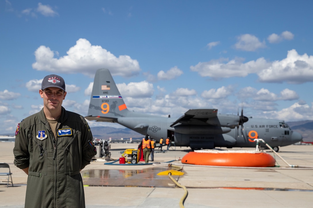 Capt. Dylan Weber, the Air Expeditionary Group’s MAFFS Scheduler, 152nd Operations Group, stands in front of a Nevada Air National Guard C-130 equipped with the MAFFS unit.