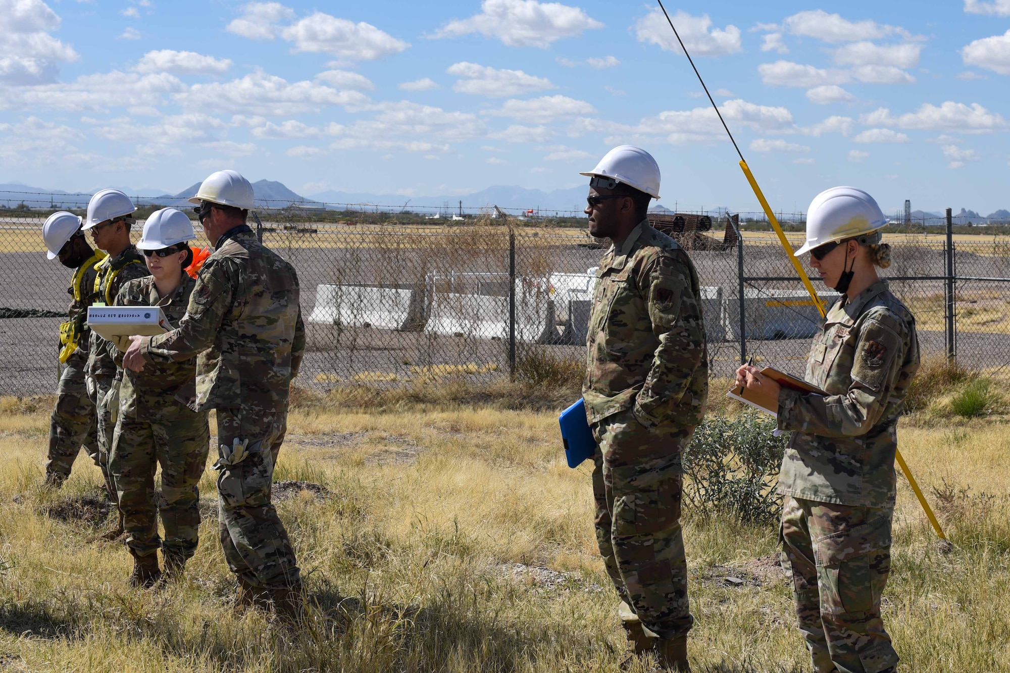 A photo of Airmen standing in a line during a simulated search and rescue exercise.