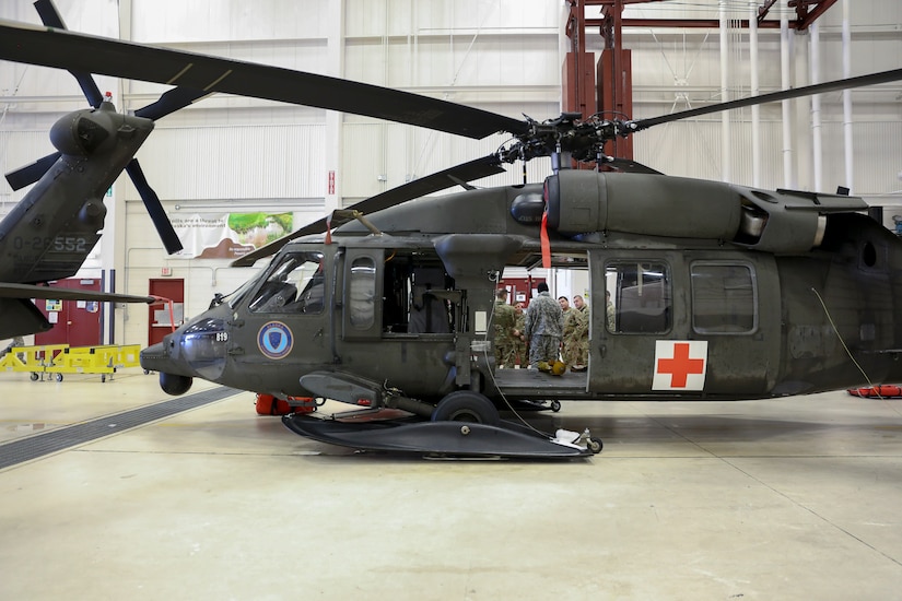 Alaska Army Guardsmen from Detachment 2, Golf Company, 2nd General Support Aviation Battalion, 104th Regiment, instruct U.S. Army Alaska scouts from Headquarters Troop, 1st Squadron (Airborne), 40th Cavalry Regiment, during a medical evacuation and hoist familiarization training at Bryant Army Airfield on Joint Base Elmendorf-Richardson, Alaska, Feb. 19, 2019.