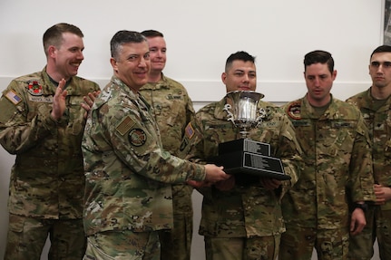 Maj. Gen. Torrence Saxe, adjutant general of the Alaska National Guard, presents the Governor’s Trophy to Golf Company, Detachment 2, 2-211th General Support Aviation Battalion in an award ceremony held at Bryant Army Airfield, Alaska, April 29, 2022.