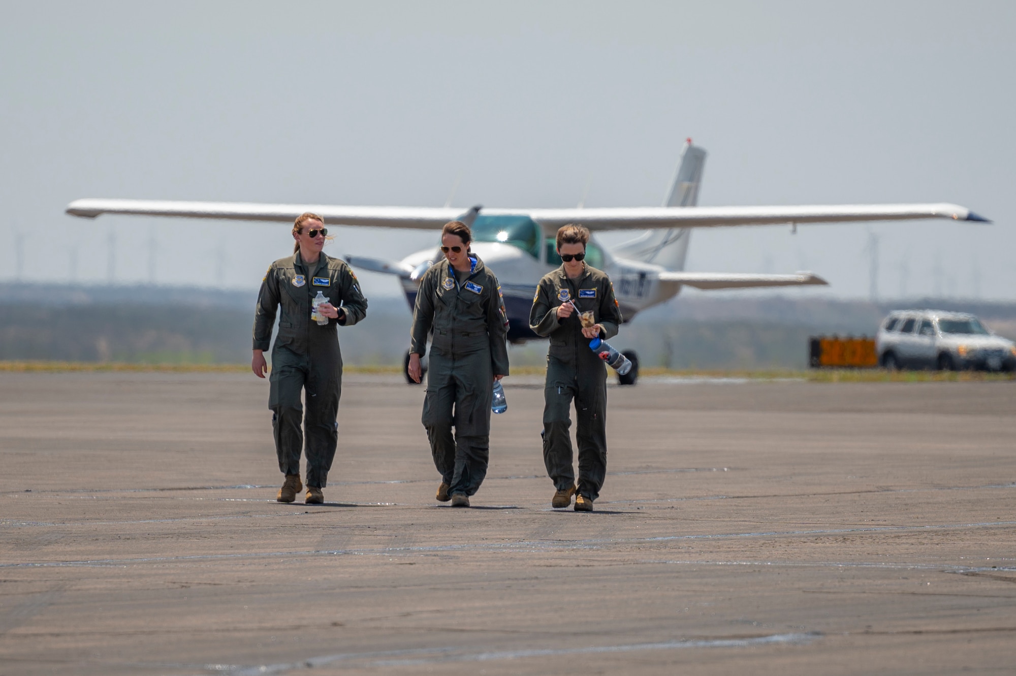 Three pilots from the 40th Airlift Squadron walk to a C-130J Super Hercules on the Avenger Field tarmac in Sweetwater, Texas, during the 80th Women Airforce Service Pilot Homecoming, April 30, 2022. The 80th WASP Homecoming was held in conjunction with the Dyess Women’s Summit in honor of the WASP program and to teach attendees about the contributions women have made to the U.S. military. (U.S. Air Force photo by Senior Airman Reilly McGuire)