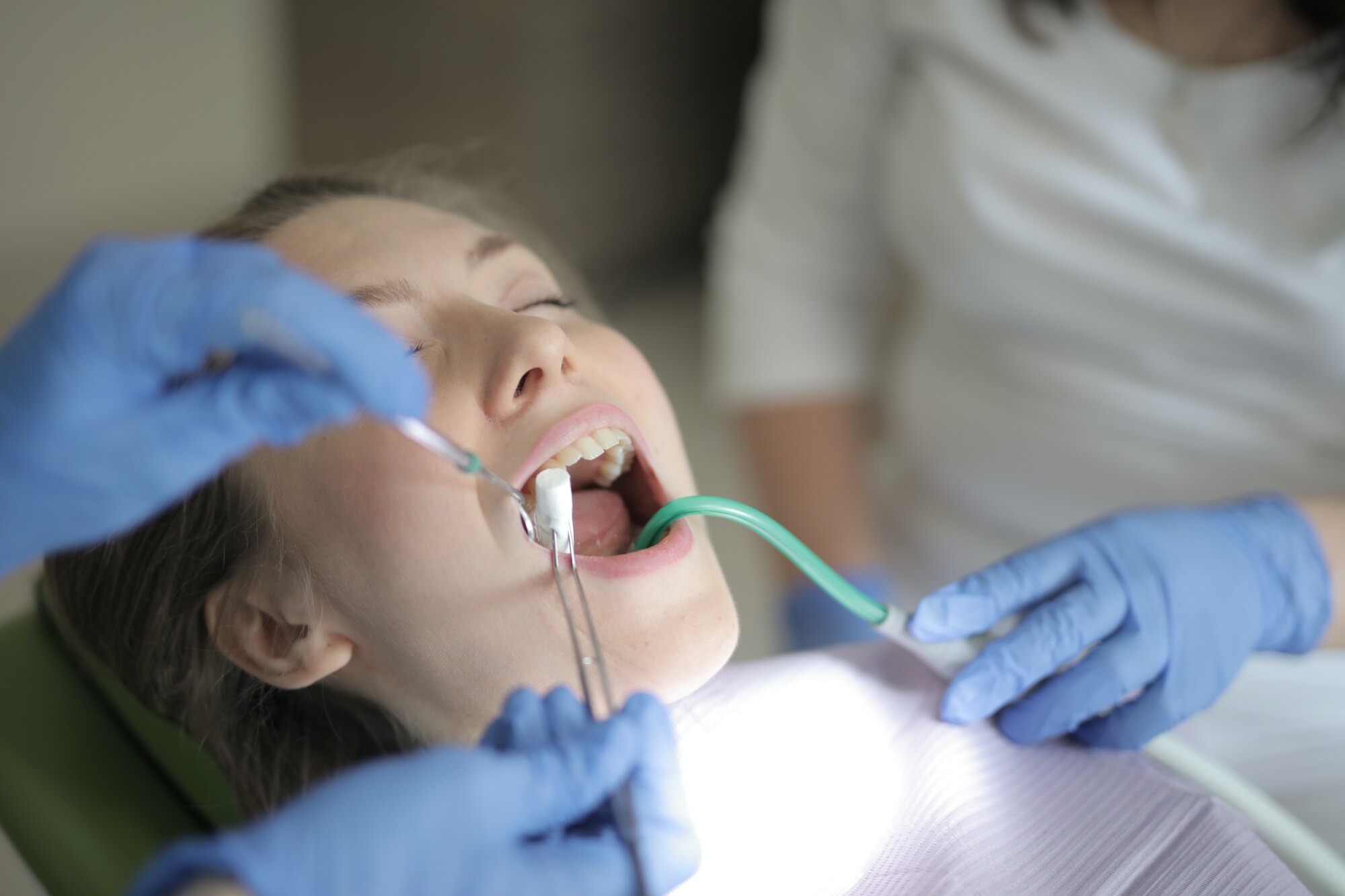 Dentist works on patient's teeth