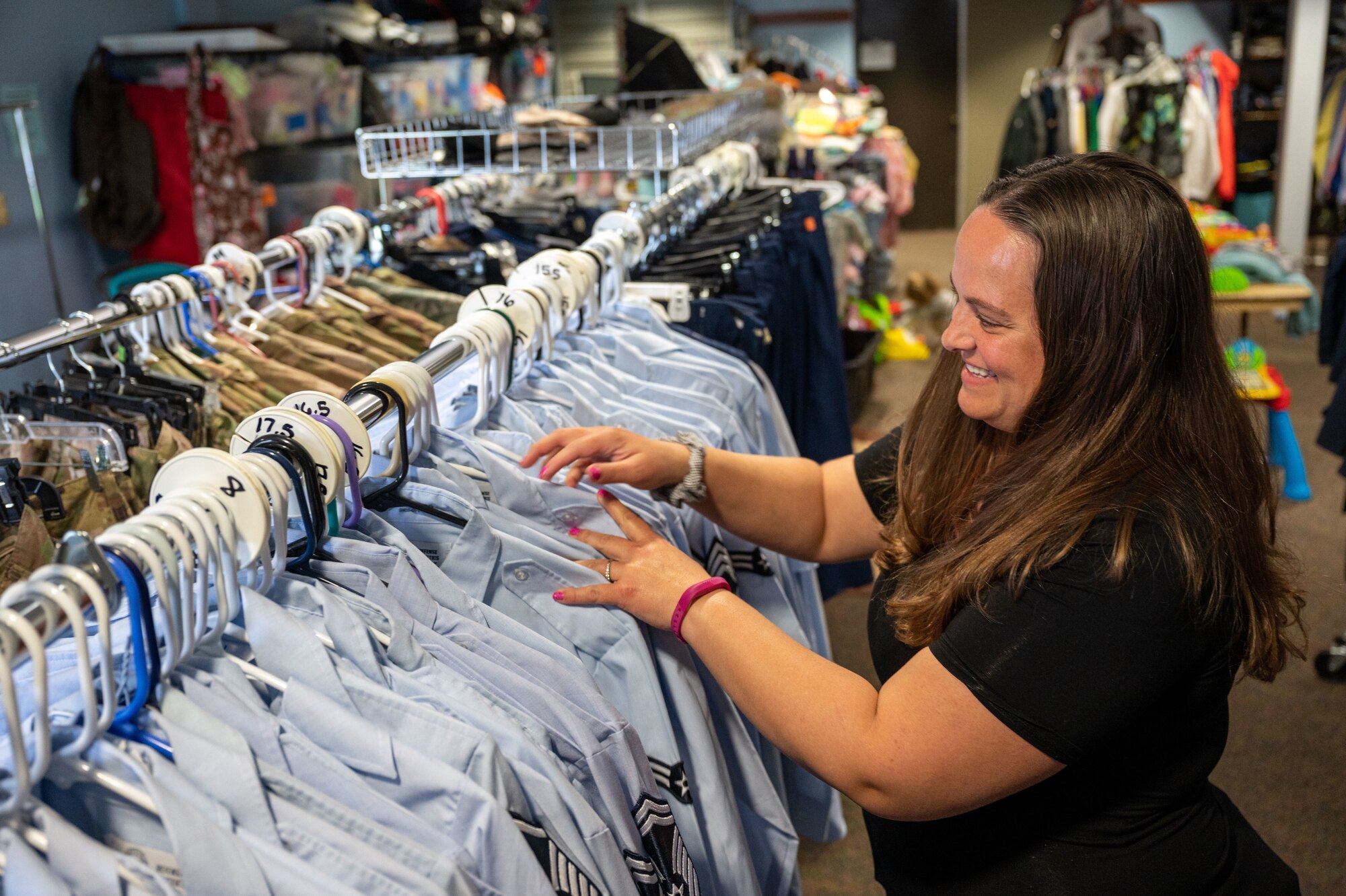 Andrea Sierra organizes uniforms at the Airman’s Attic on Dover Air Force Base, Del., April 6, 2022. A military spouse for eight years, Sierra is a member of the Dover Spouse’s Club and plays an active role in the community. (U.S. Air Force photo by Airman 1st Class Cydney Lee)