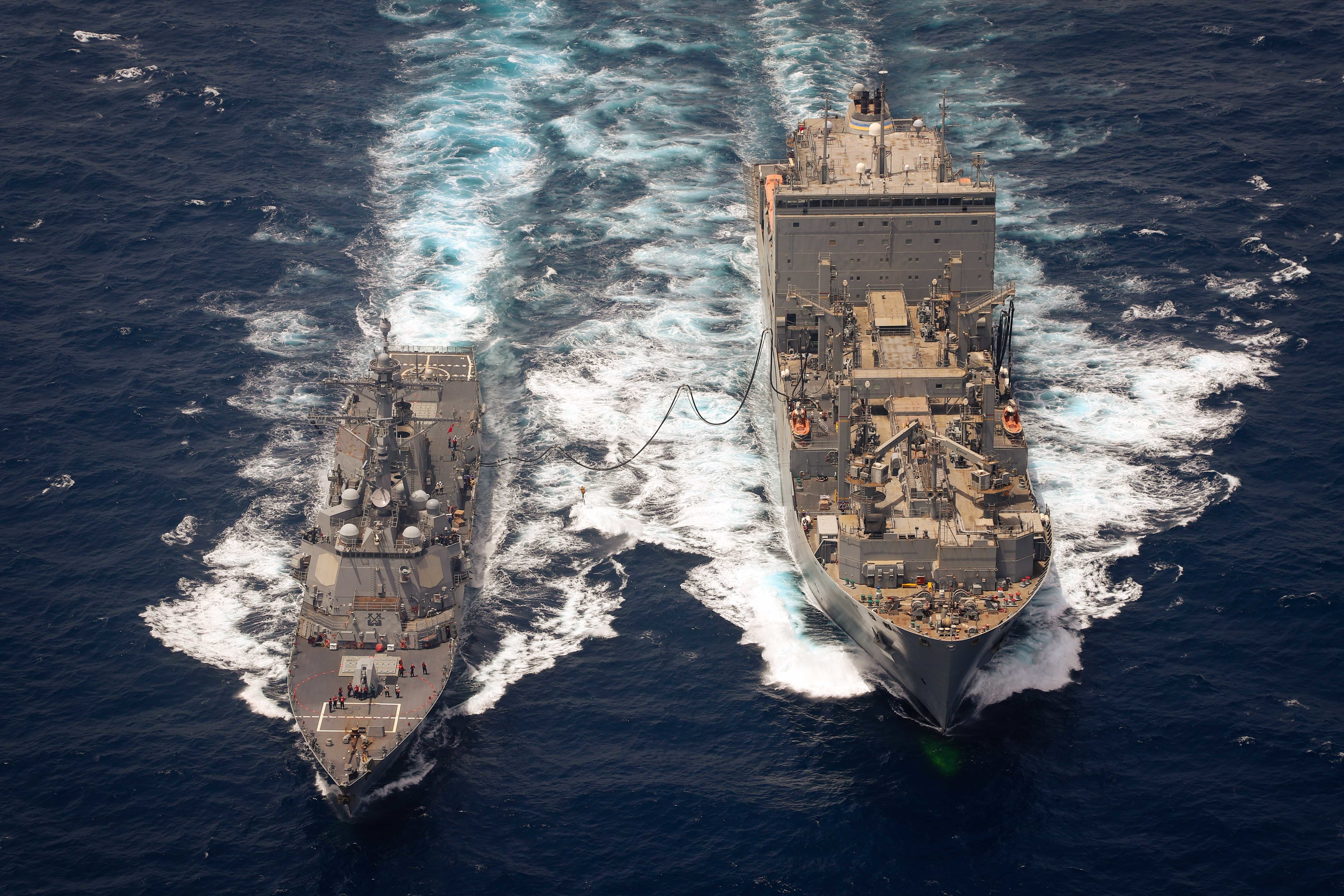 The guided-missile destroyer USS Momsen (DDG 92) conducts a replenishment-at-sea with dry cargo and ammunition ship USNS Charles Drew (T-AKE 10) in the Arabian Sea.