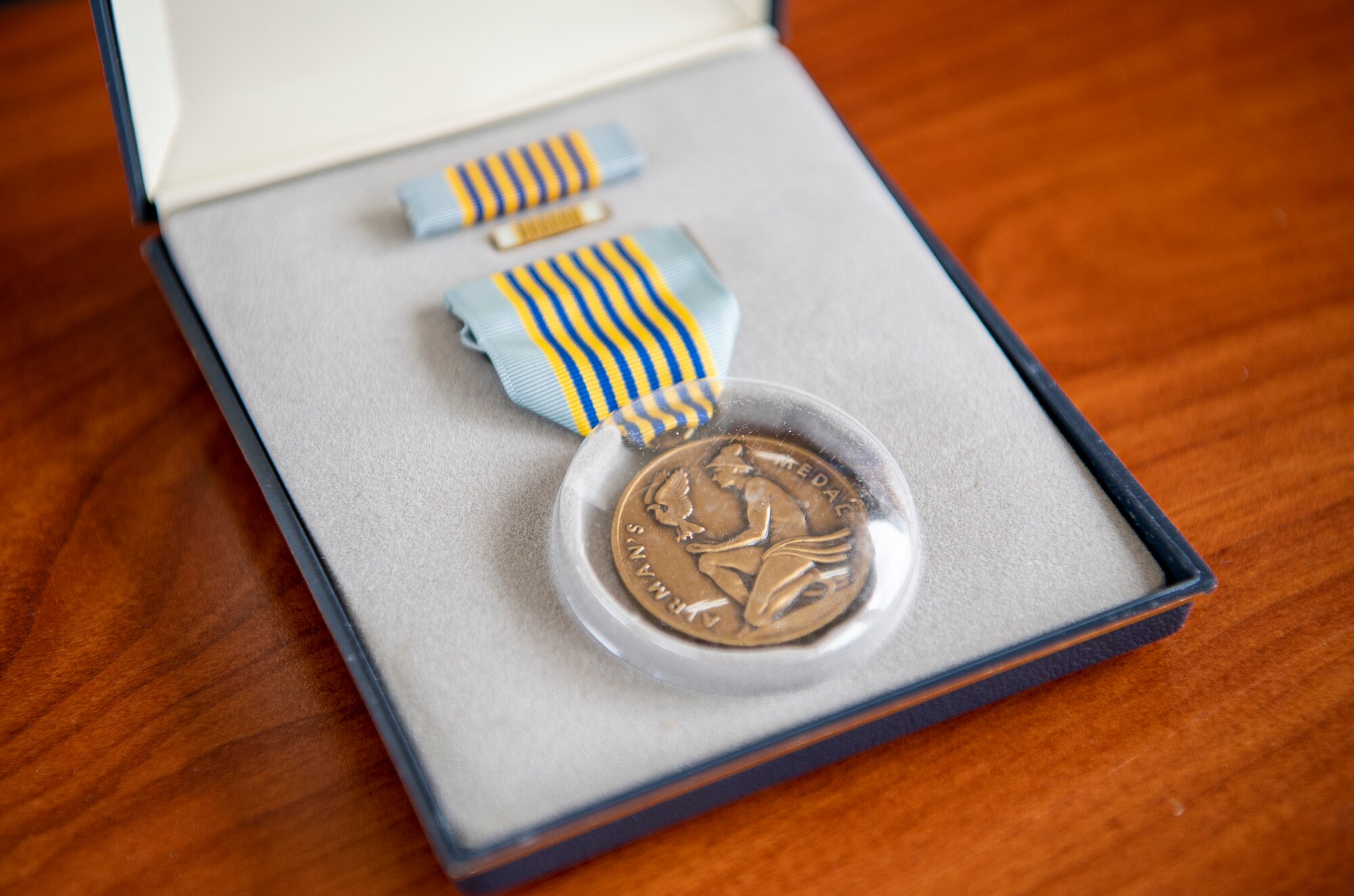 The Airman’s Medal, the highest award given to Air Force members outside combat, rests on a table before a ceremony at Coast Guard Marine Safety Security Team Houston, Texas, April 26, 2022. Air Force personnel presented the award to the family of Elijah Posana, an airman who gave his life rescuing his cousins from a rip current on Surfside Beach, Texas, May 2, 2021. (U.S. Coast Guard photo by Petty Officer 1st Class Corinne Zilnicki)