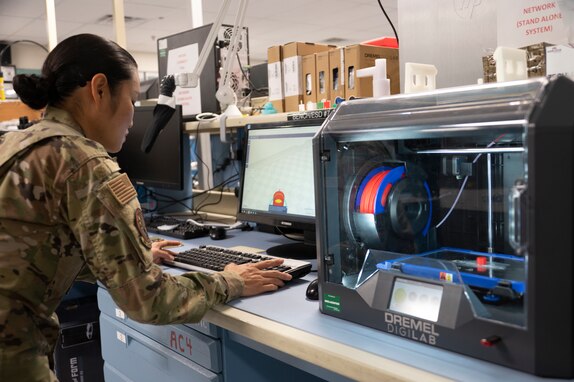 A 595 SCS Airman conducts 3-D printing for a SACCS light lens.